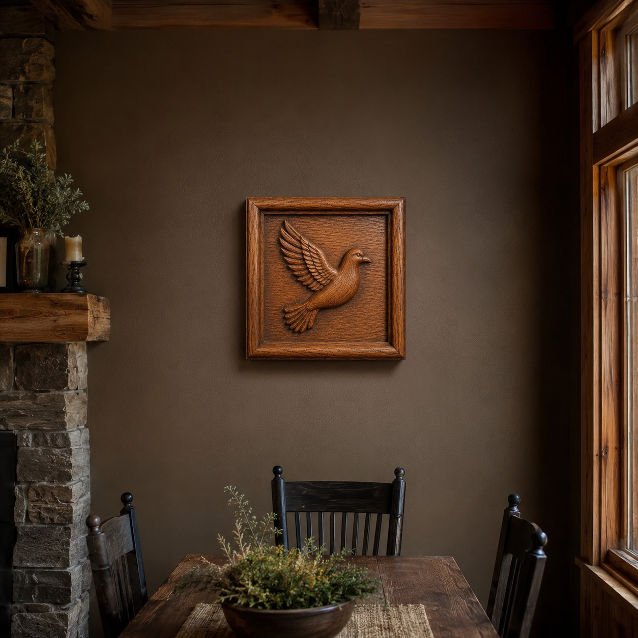 A rustic dining room features a wooden table, black chairs, stone fireplace, and the Flying Dove Relief STL File | Dove Bird CNC Wall Art by Form Arcade on a brown wall, with natural light streaming through the window.