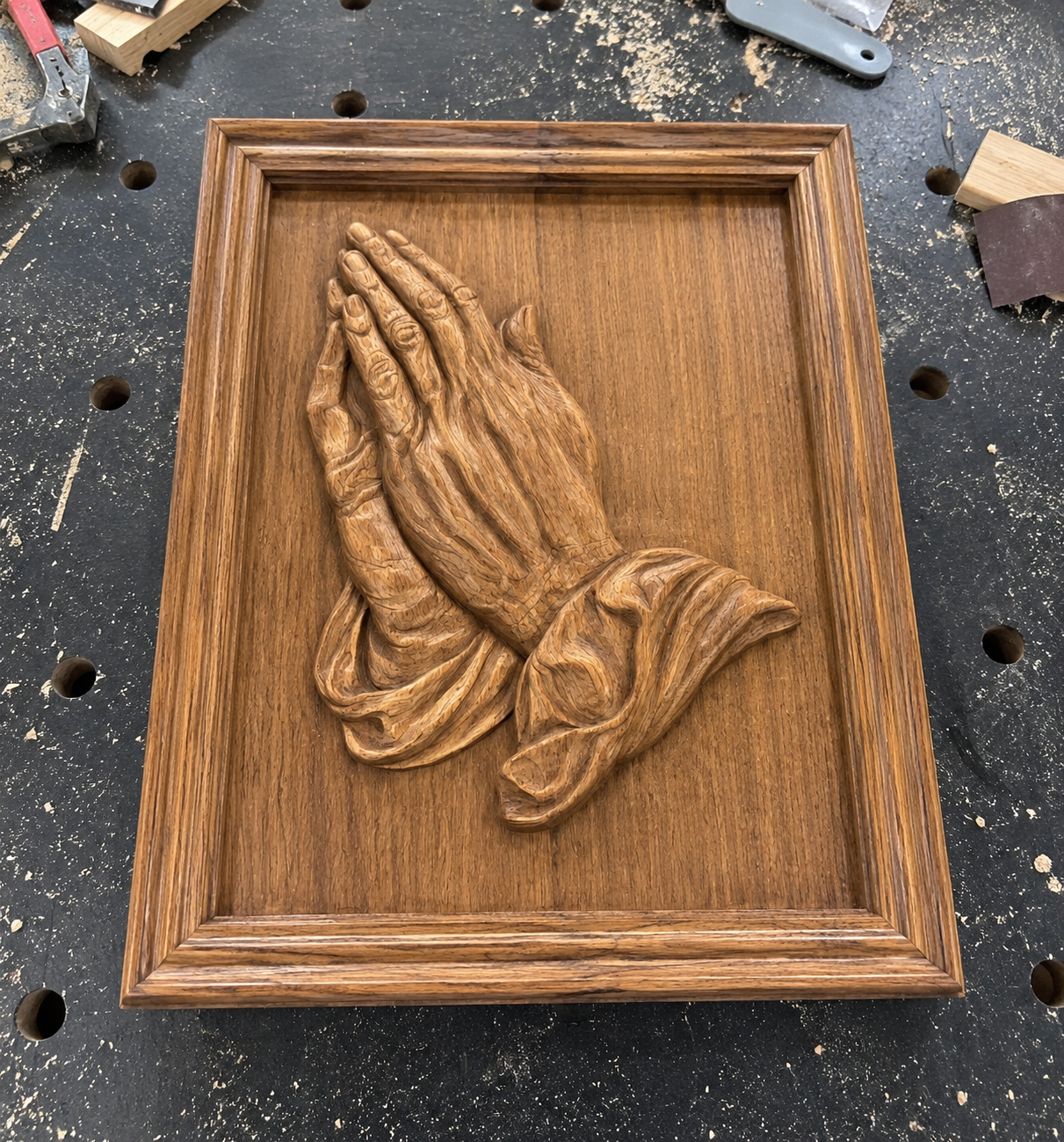 The Praying Hands Relief STL File by Form Arcade is a religious CNC wall art design featuring two hands pressed together in prayer, with draped sleeves, ideal for creating detailed wooden plaques.