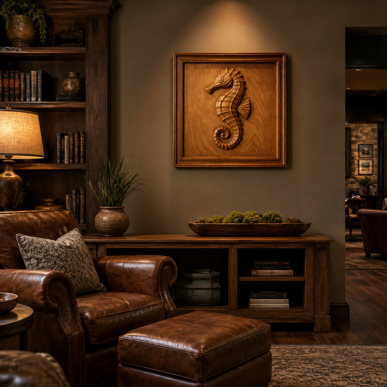 A cozy study features a leather armchair, ottoman, wooden bookshelves, a lamp, and a potted plant. On the wall hangs the Seahorse CNC Relief STL File | Ocean CNC Wall Art from Form Arcade. Warm lighting enhances the inviting, rustic atmosphere—perfect inspiration for woodworking projects or fans of CNC relief carving.